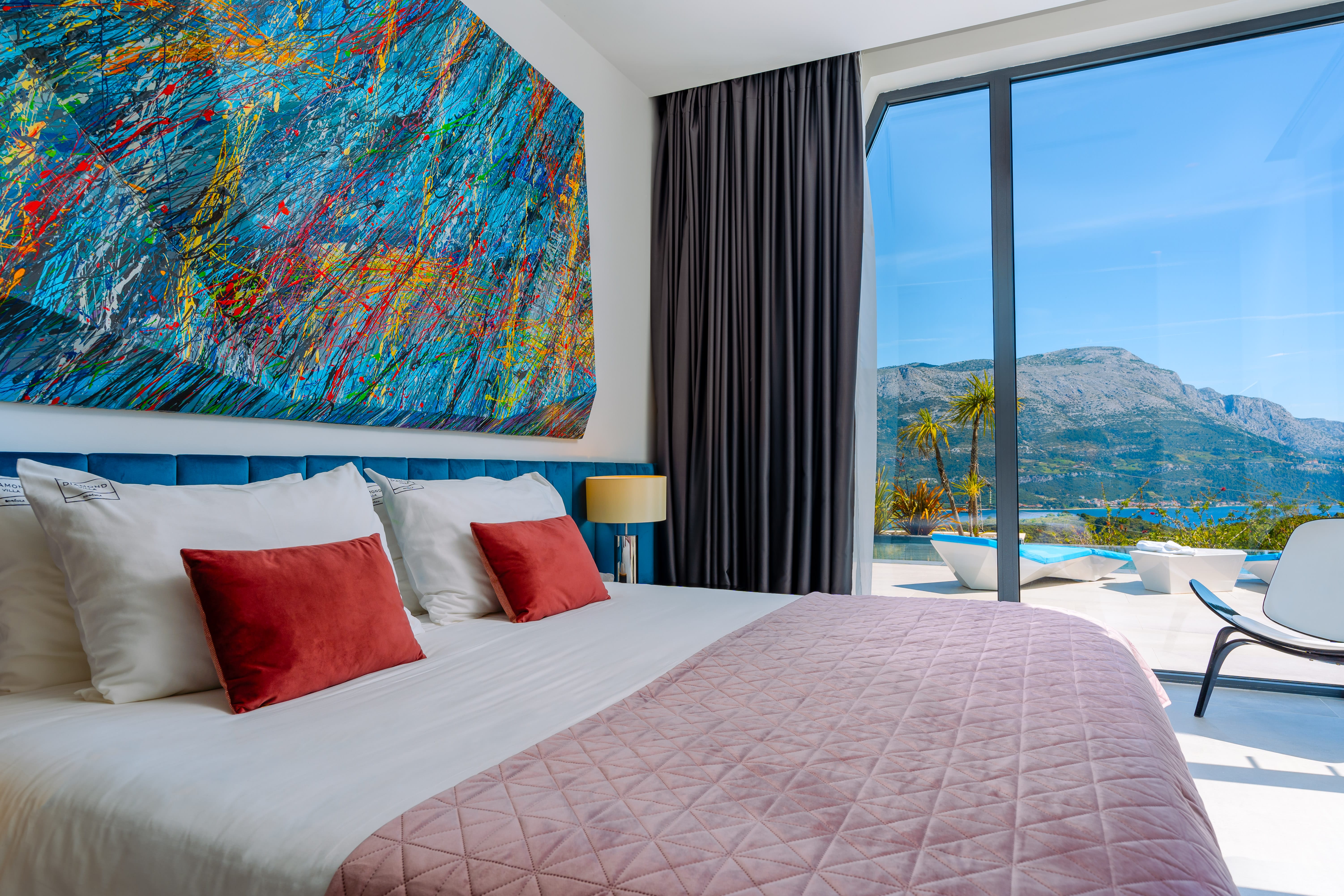 King-sized modern bedroom with exit to the pool terrace with sea view in Villa Korcula Gem