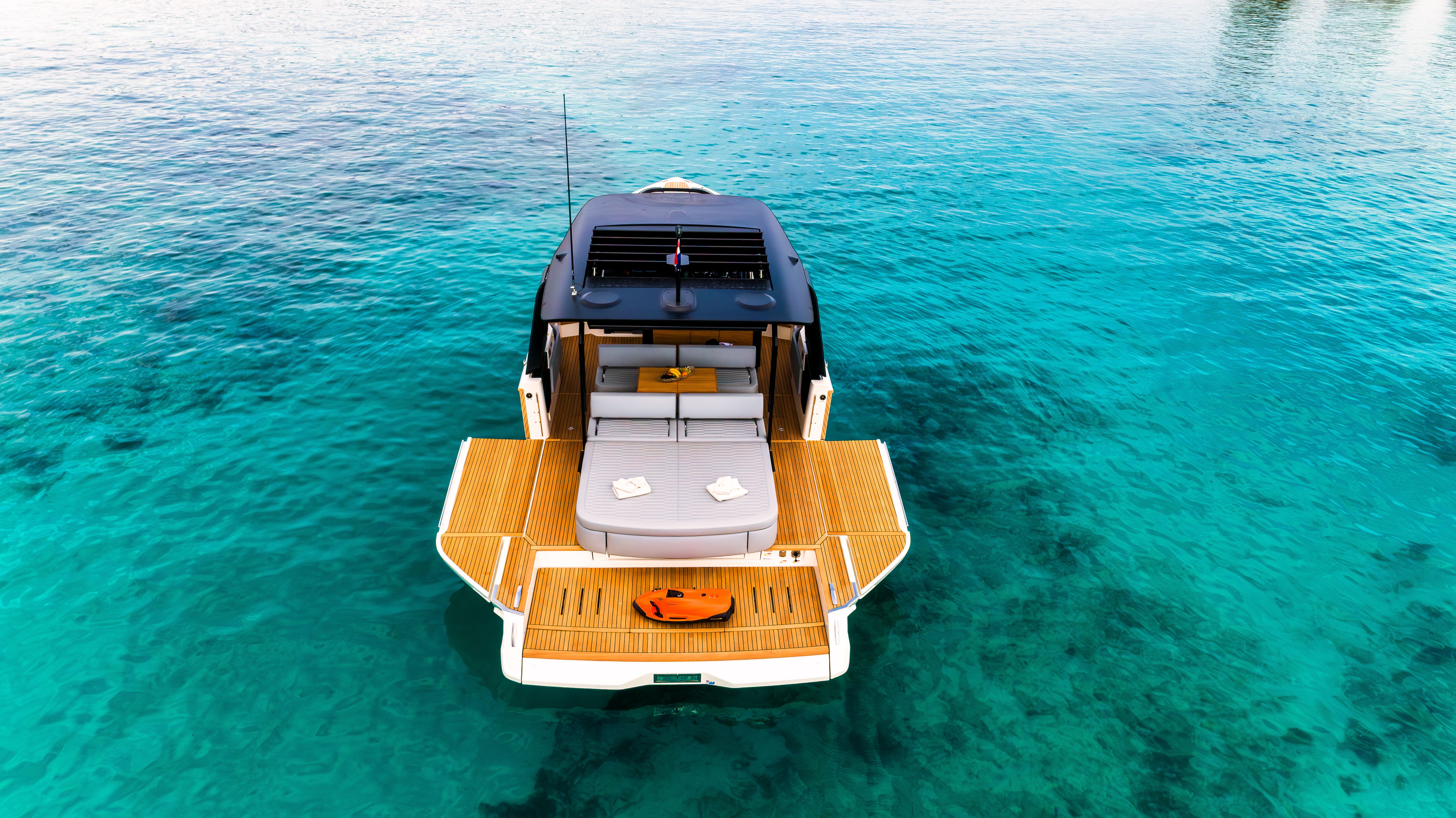 Aerial view of Cranchi A46 luxury tender with a spacious deck in clear turquoise water.