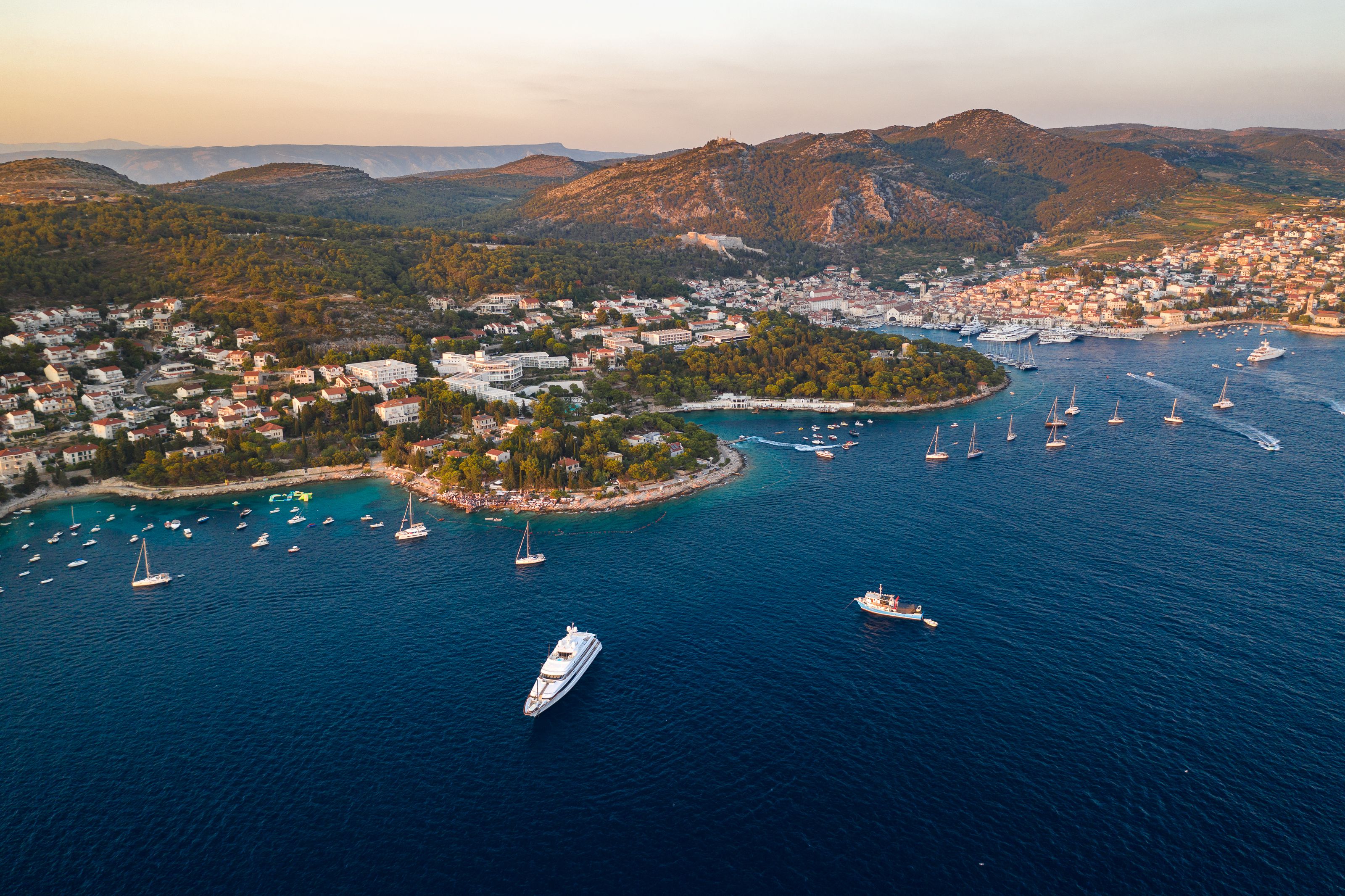 Aerial view of Hvar island, Croatia at sunset, showcasing the stunning coastline and the town of Hvar in the distance
