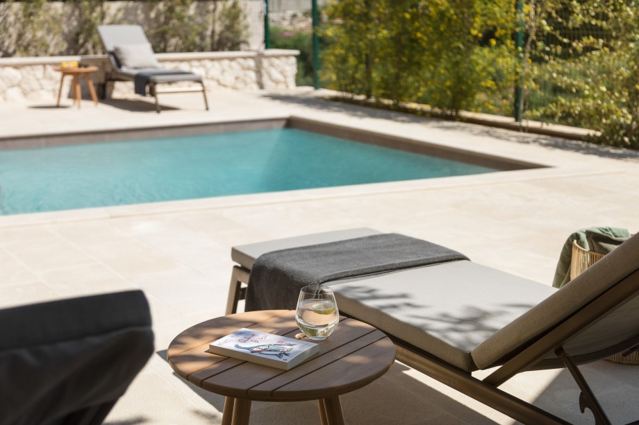 Pool terrace with sunbed and a pool in Villa Dorothea Hvar