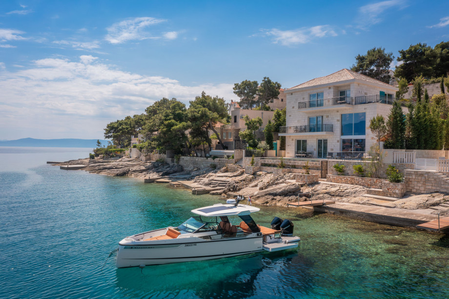 Beautiful villa on the island of Brac with a pool and a motor boat in front